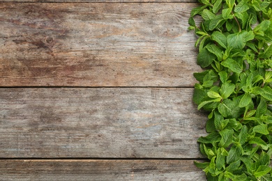 Fresh aromatic mint on wooden background, top view