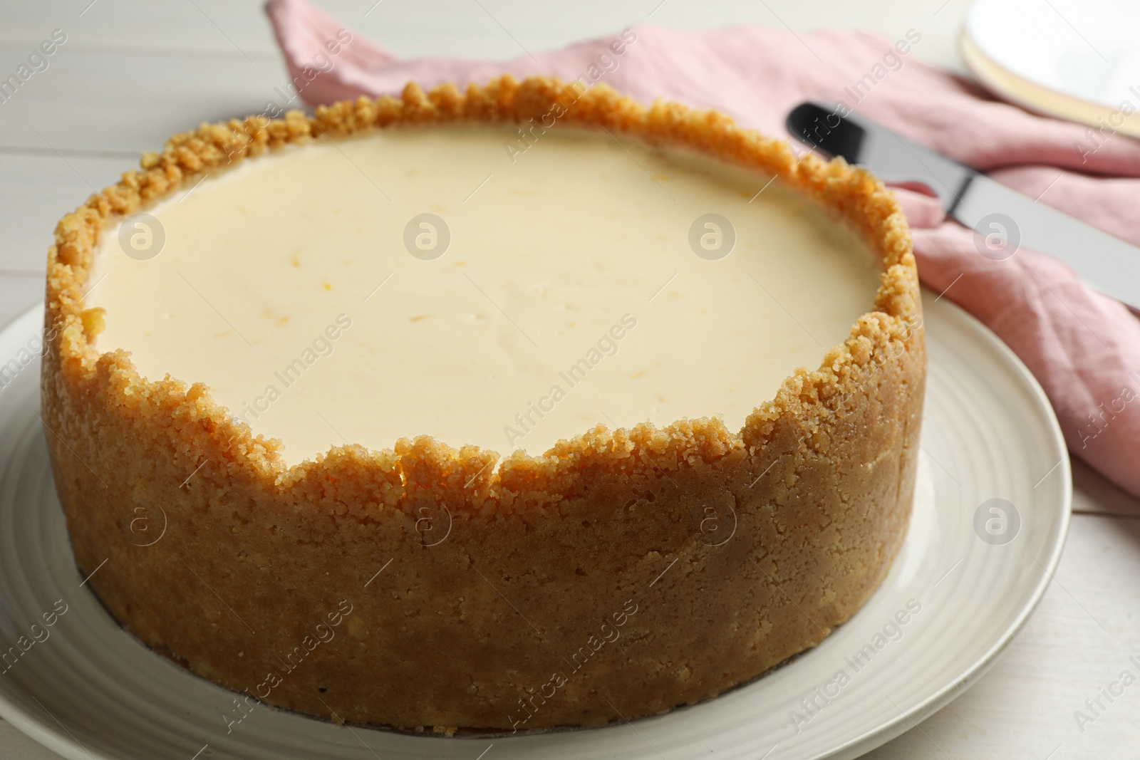 Photo of Tasty vegan tofu cheesecake on white table, closeup