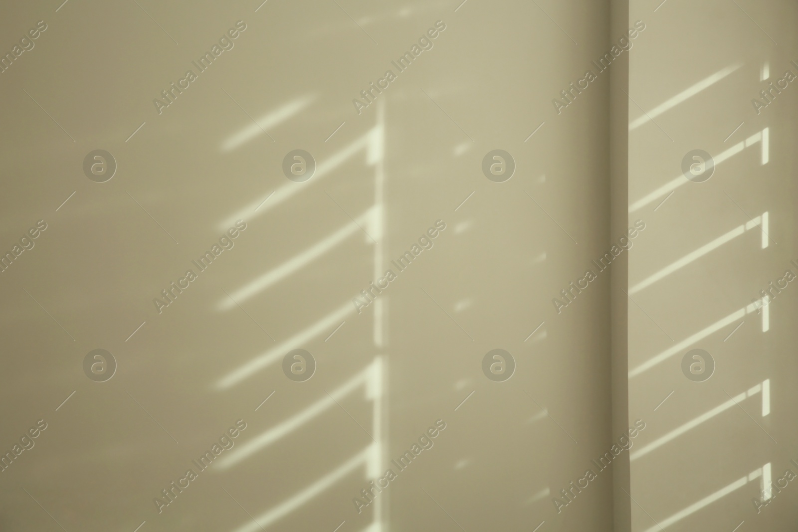 Photo of Lines made of light and shadows on white wall