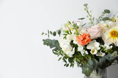 Photo of Bouquet of beautiful flowers in vase on white background, closeup. Space for text