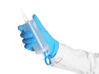 Doctor in medical glove holding large empty syringe on white background