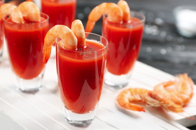 Photo of Delicious shrimp cocktail with tomato sauce served on table, closeup