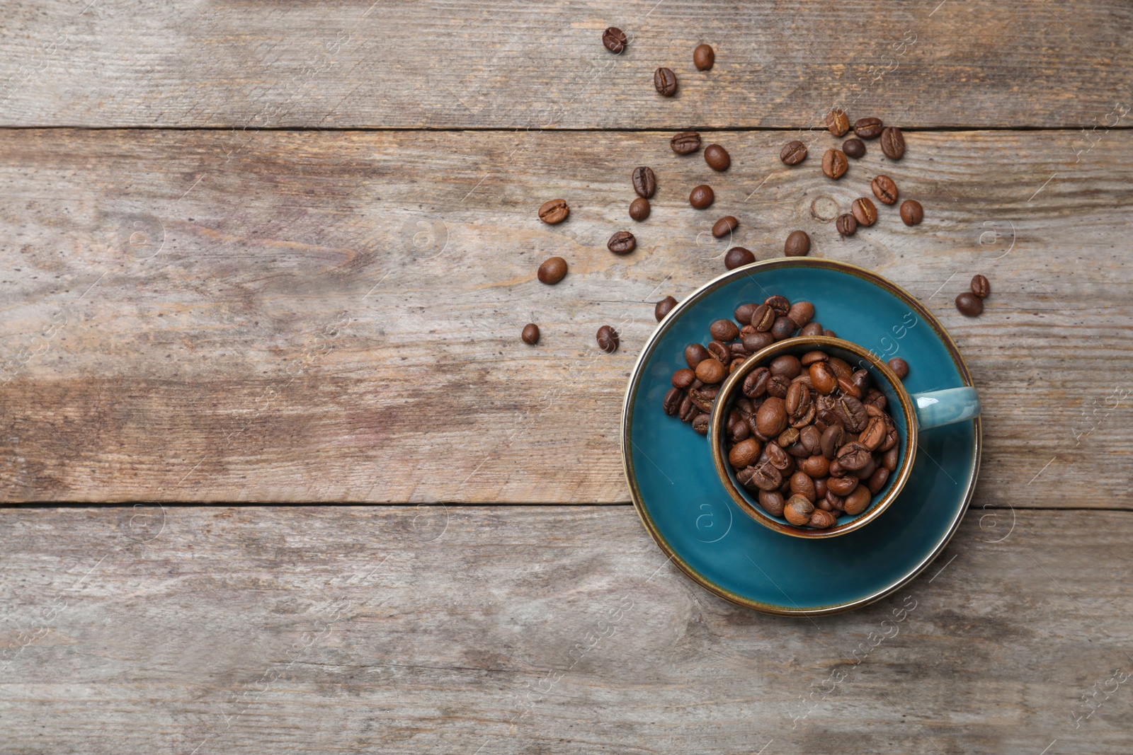 Photo of Flat lay composition with cup and coffee beans on wooden background