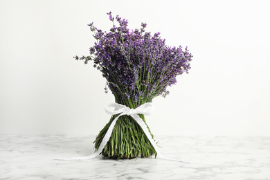 Beautiful lavender bouquet on marble table against white background