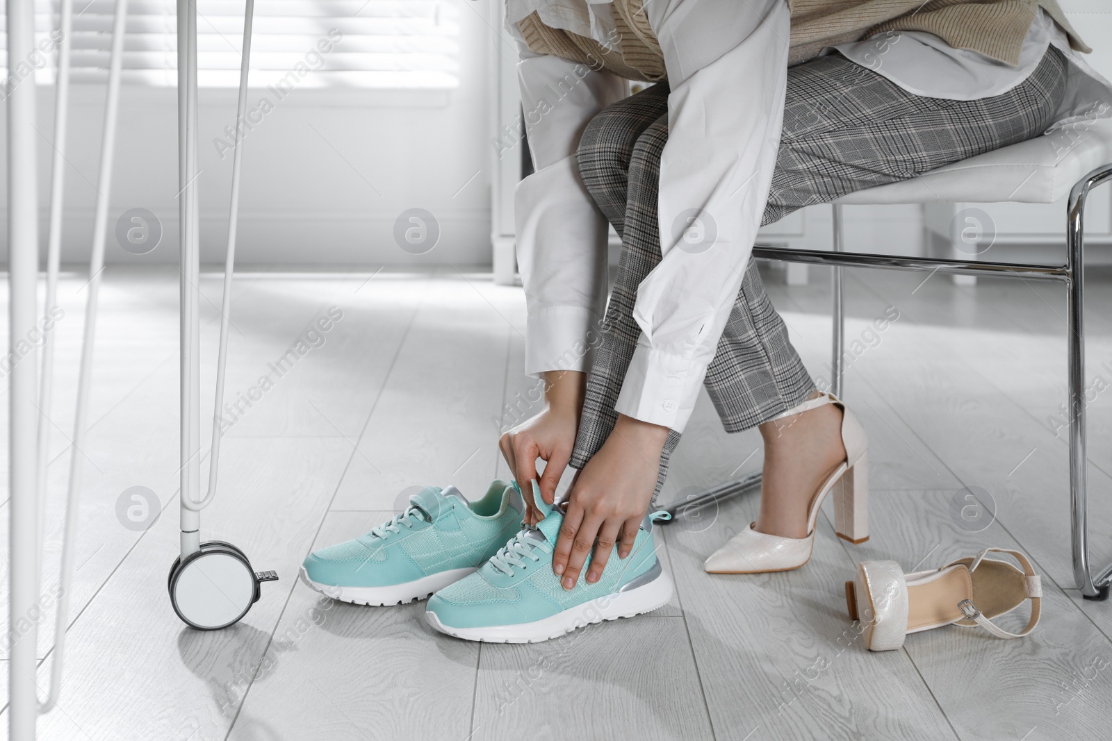 Photo of Woman changing shoes at workplace in office, closeup