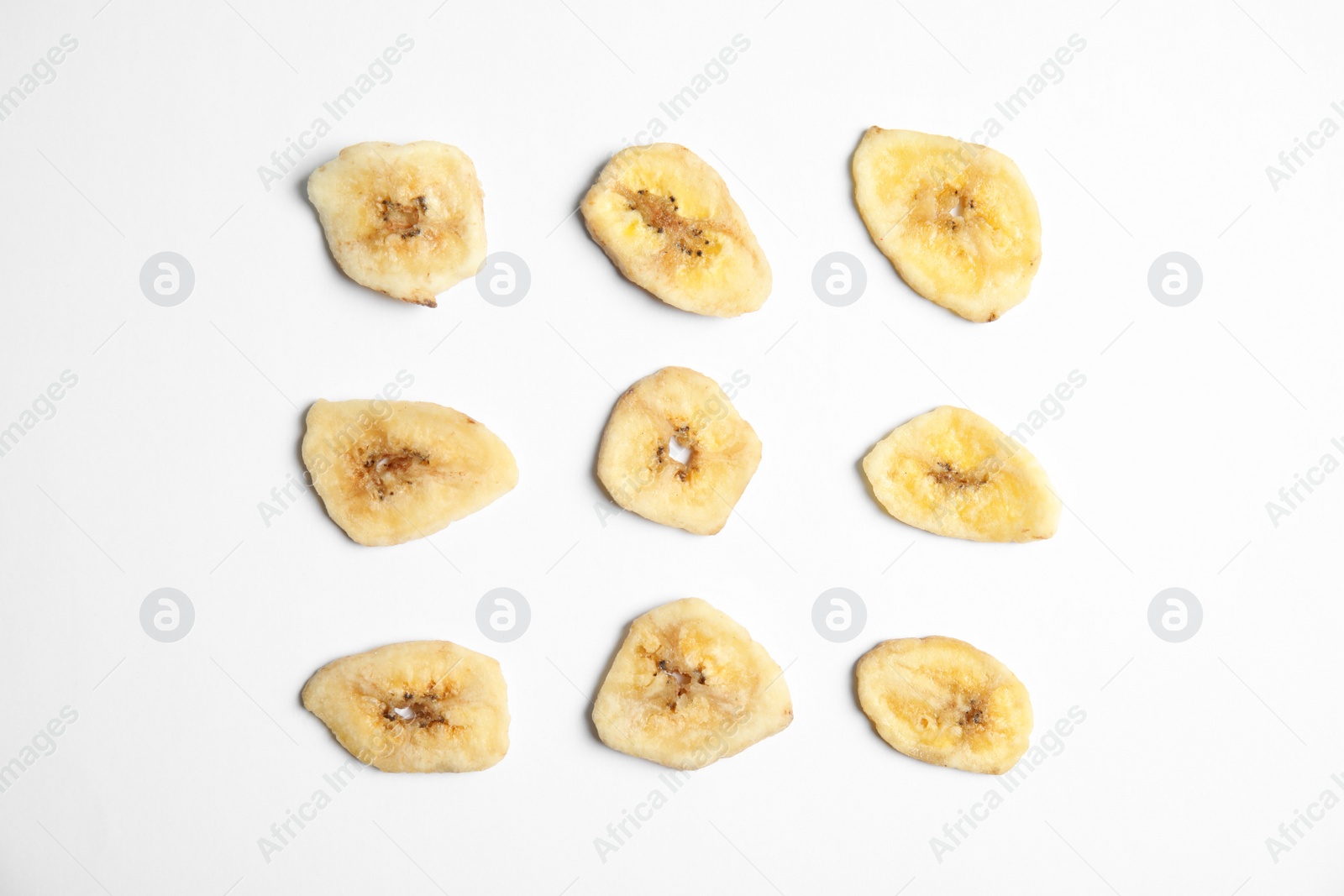 Photo of Flat lay composition with banana slices on  white background. Dried fruit as healthy snack