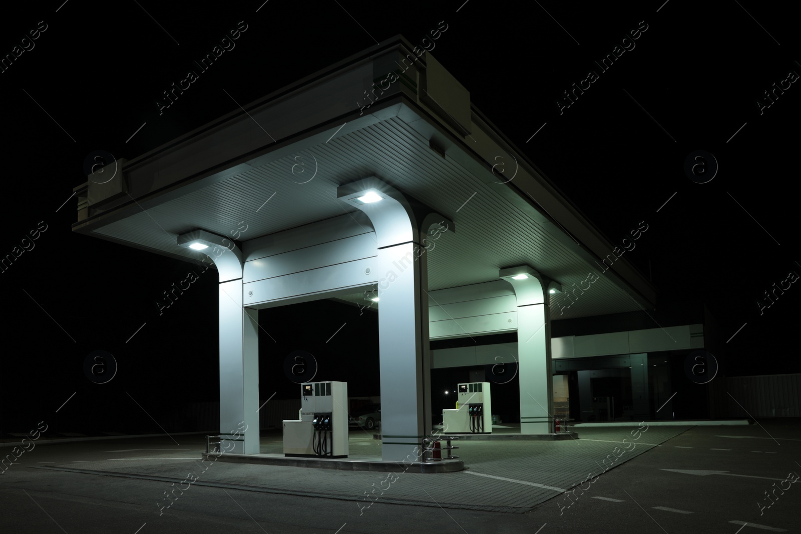 Photo of Modern gas station with convenience store beside the road at night