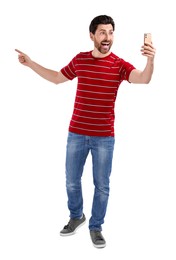 Photo of Happy man taking selfie with smartphone on white background