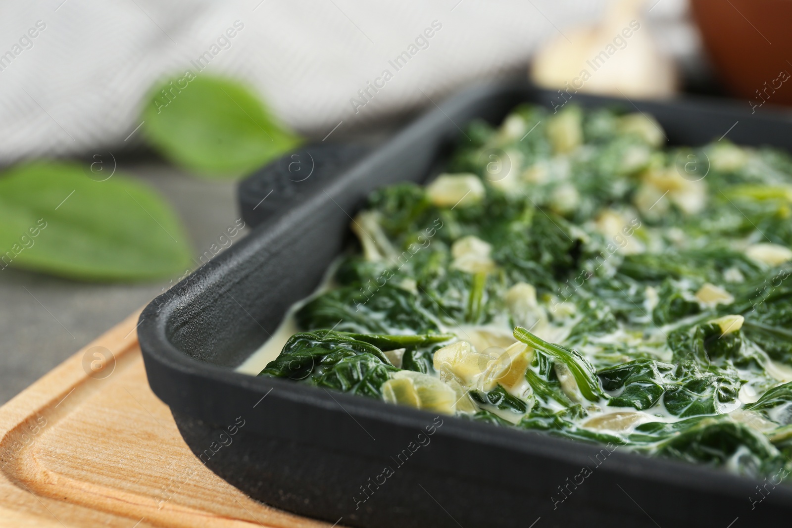 Photo of Tasty spinach dip on table, closeup view