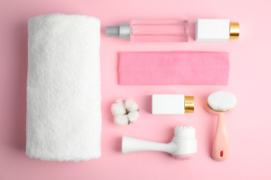 Photo of Flat lay composition with face cleansing brushes on pink background. Cosmetic tools