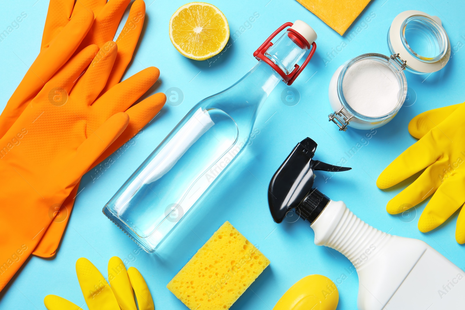 Photo of Flat lay composition with vinegar and cleaning supplies on color background