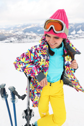 Young skier wearing winter sport clothes outdoors
