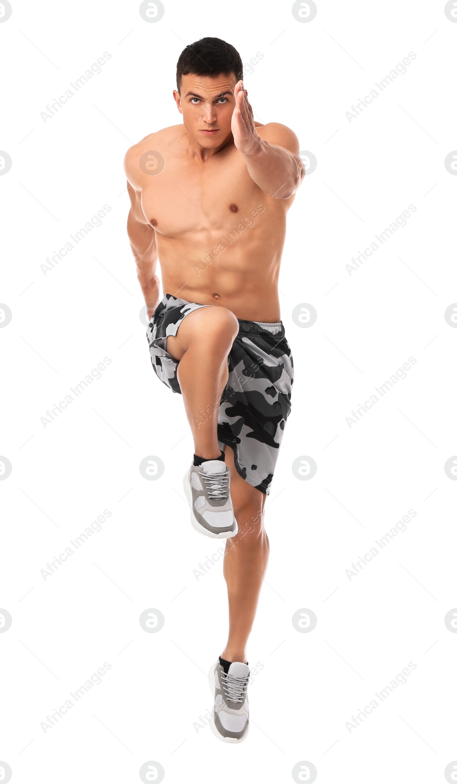 Photo of Athletic young man running on white background