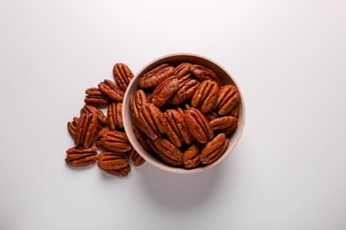 Tasty fresh ripe pecan nuts on white background, flat lay