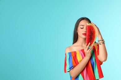 Photo of Beautiful young woman posing with watermelon on color background