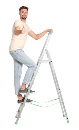 Photo of Young handsome man climbing up metal ladder on white background