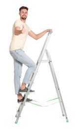 Young handsome man climbing up metal ladder on white background