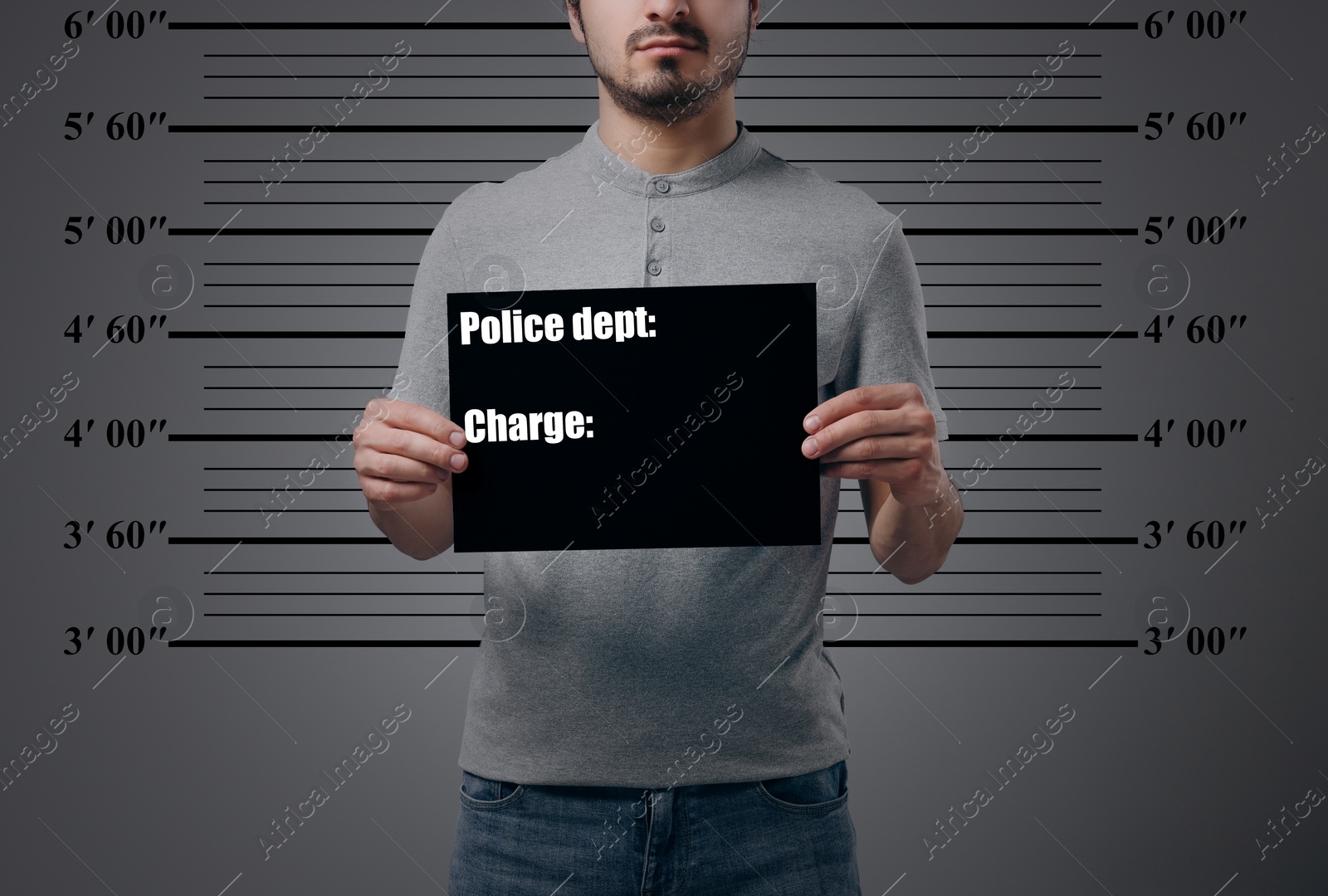 Image of Criminal mugshot. Arrested man with blank card against height chart, closeup