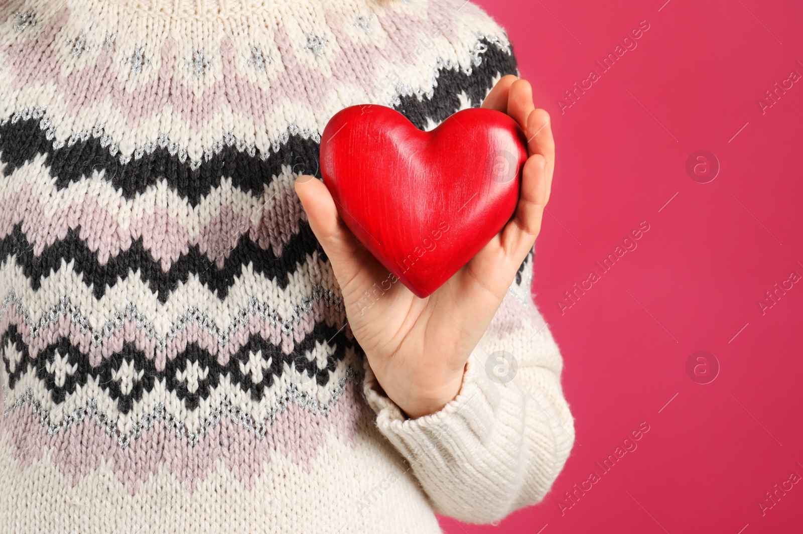 Photo of Woman holding decorative heart on color background, closeup