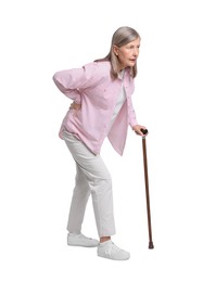 Senior woman with walking cane suffering from back pain on white background