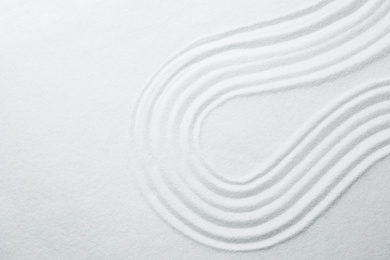 White sand with pattern as background, top view. Zen, meditation, harmony