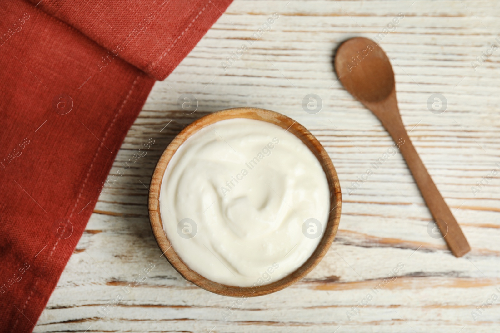 Photo of Tasty organic yogurt on white wooden table, flat lay