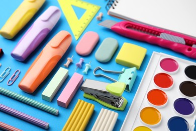 Photo of Different school stationery on light blue background. Back to school