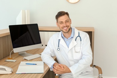 Photo of Male medical assistant at workplace in clinic. Health care service