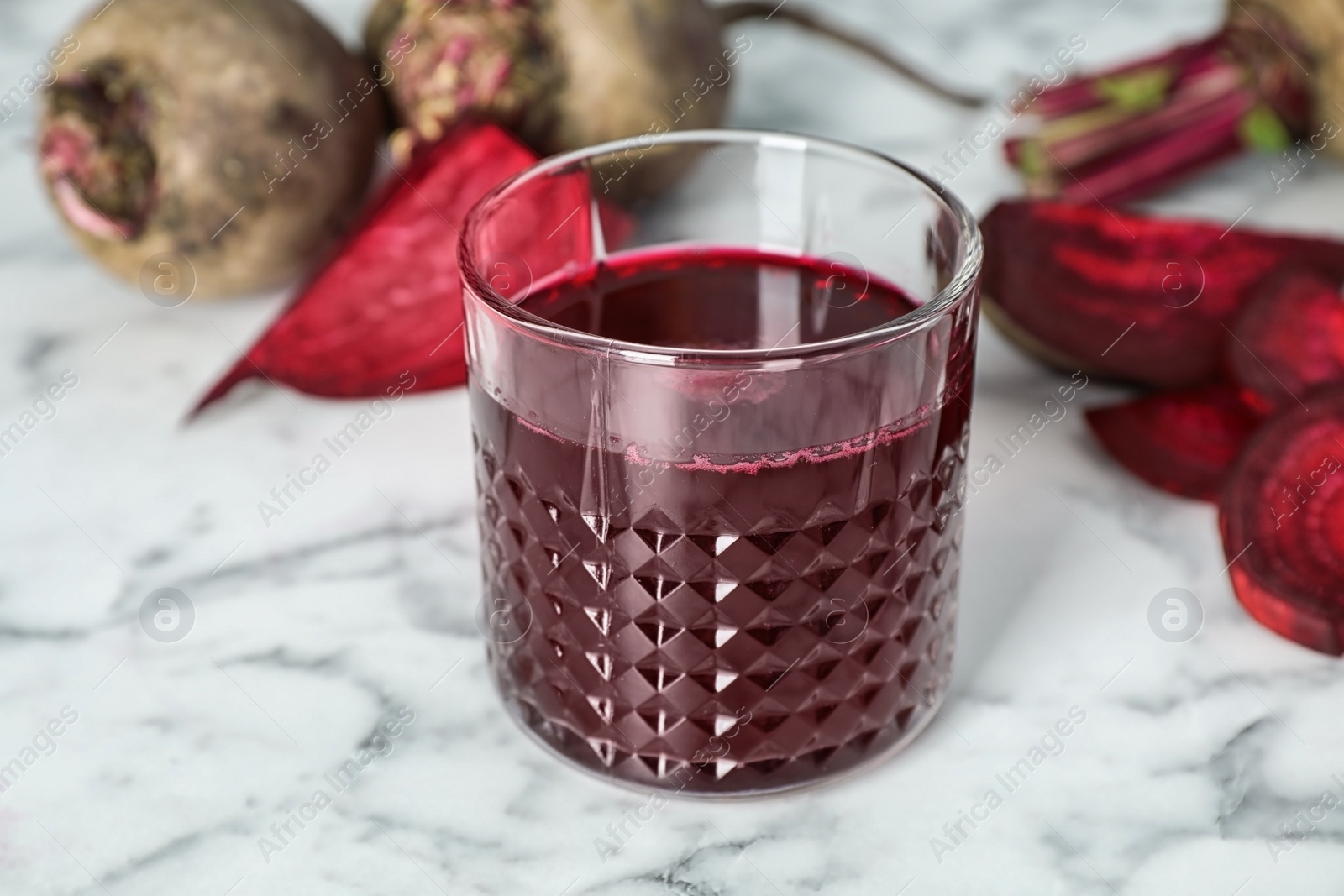 Photo of Glass with fresh healthy beet juice on table