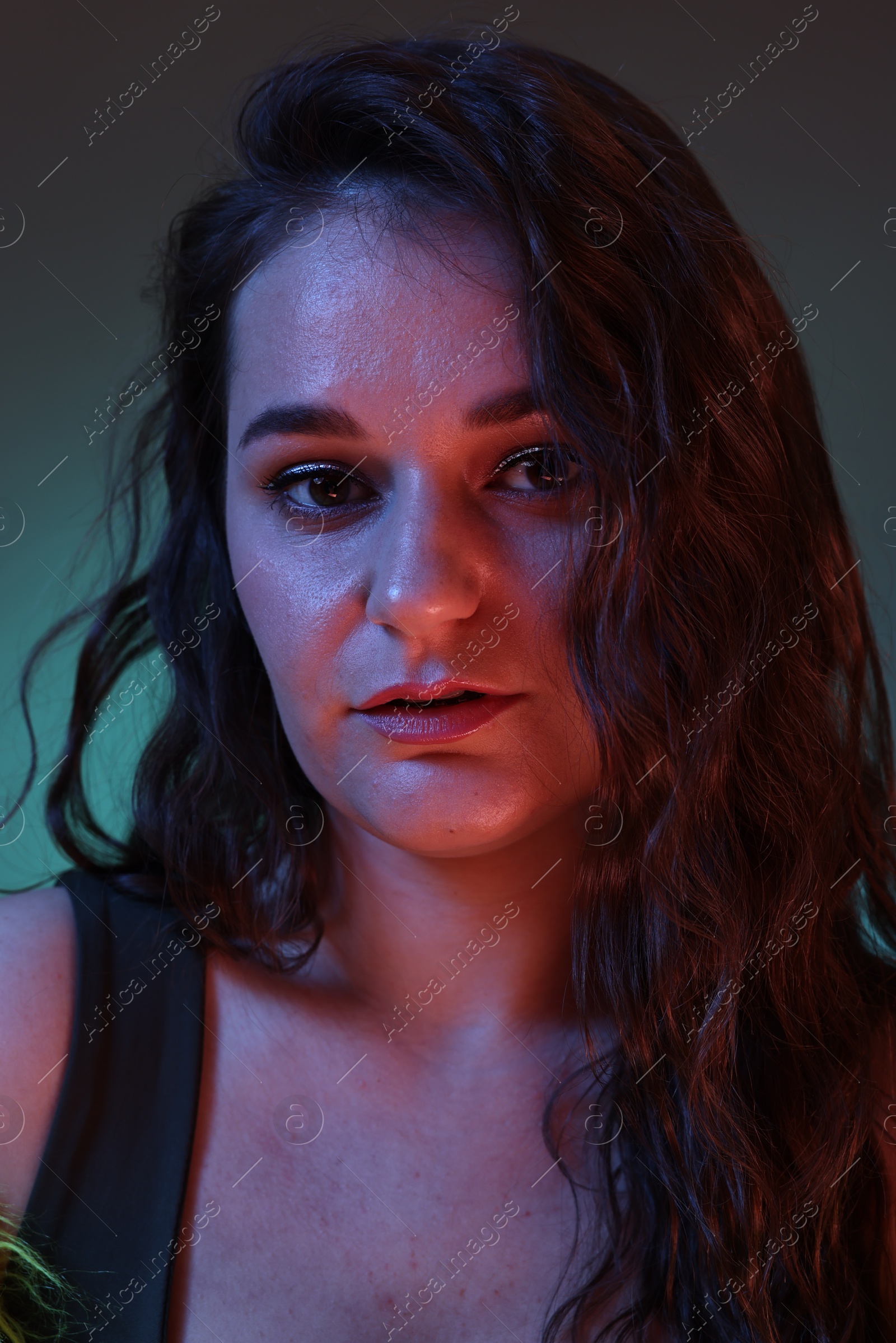 Photo of Portrait of beautiful woman on dark background with neon lights