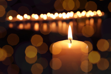 Image of Burning candle on dark background, bokeh effect