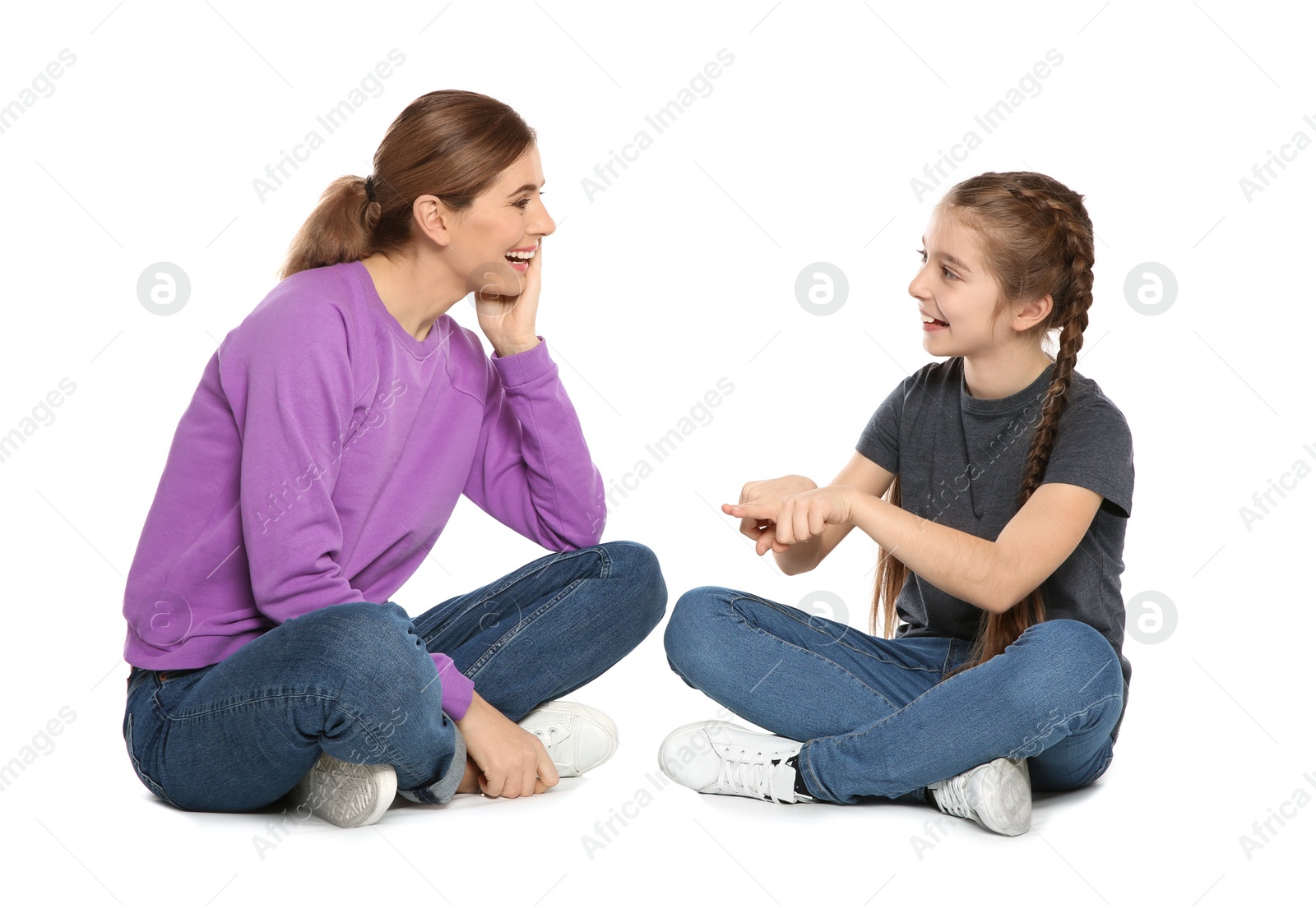 Photo of Hearing impaired mother and her child talking with help of sign language on white background