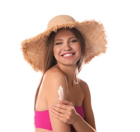 Woman applying sun protection cream on body against white background