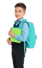 Photo of Little boy in uniform with school stationery on white background