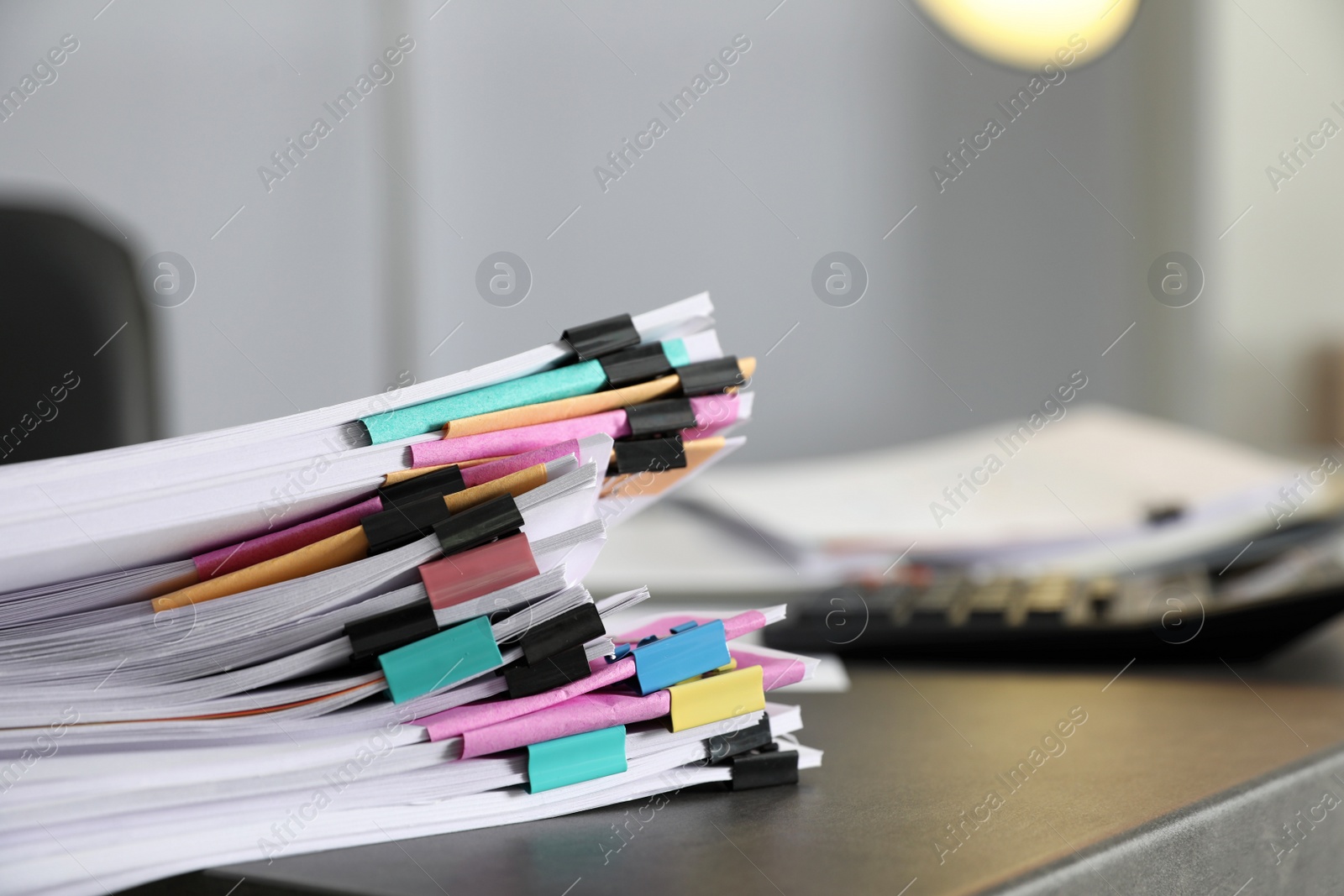 Photo of Stack of documents with paper clips on office table. Space for text