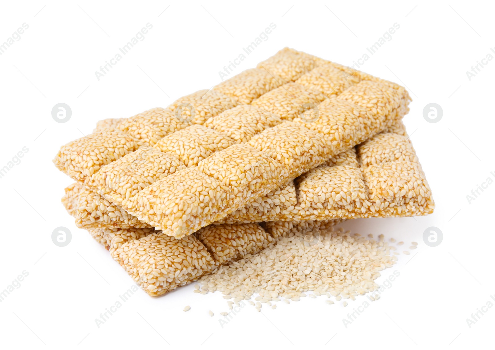 Photo of Delicious sweet kozinaki bars and sesame seeds on white background