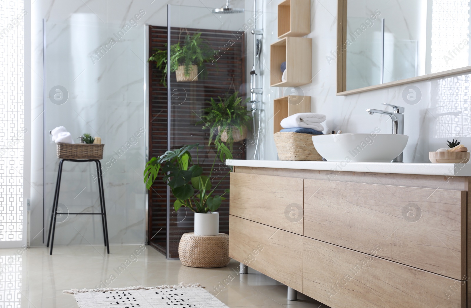 Photo of Bathroom interior with shower stall, counter and houseplants. Idea for design