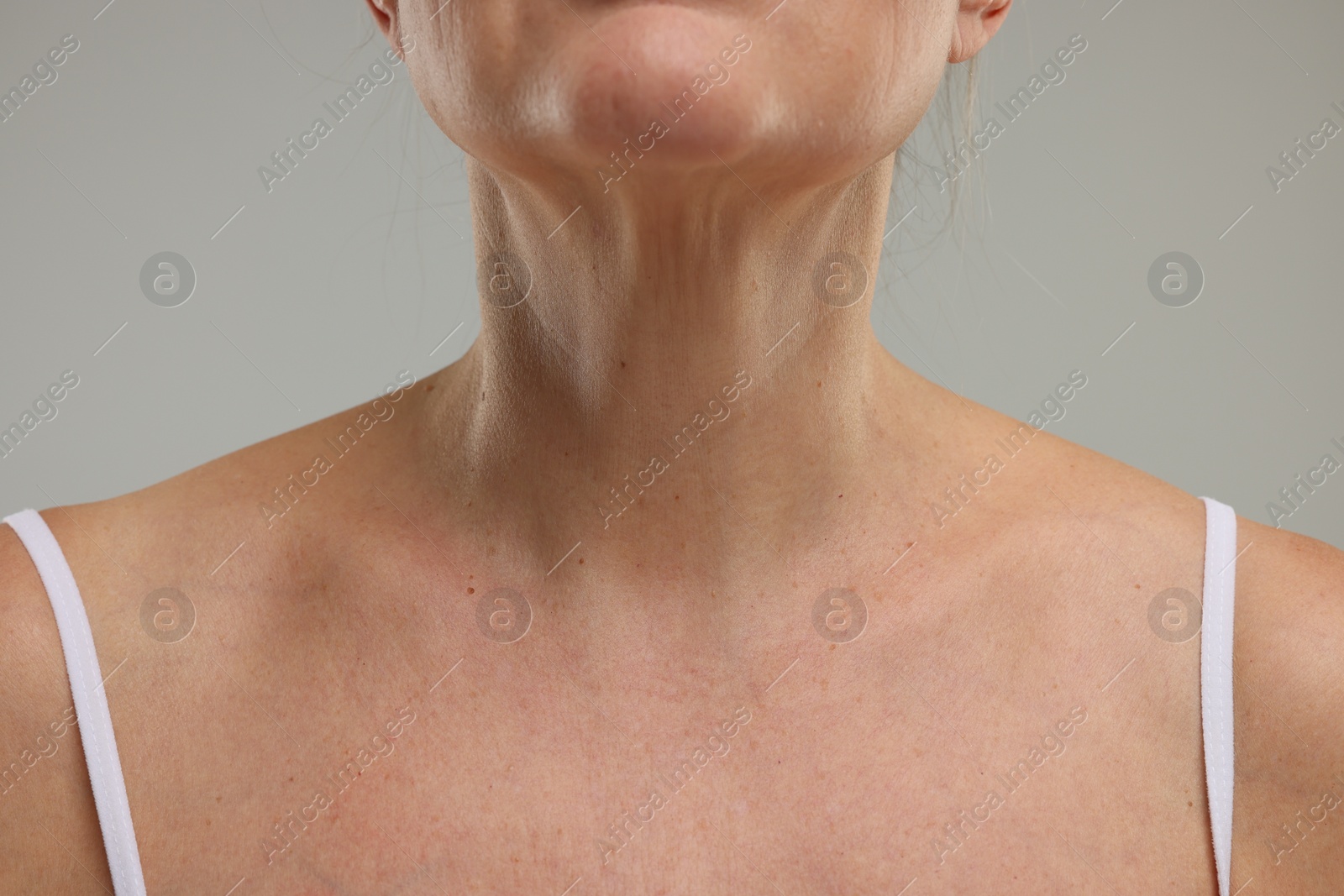 Photo of Mature woman with healthy skin on grey background, closeup