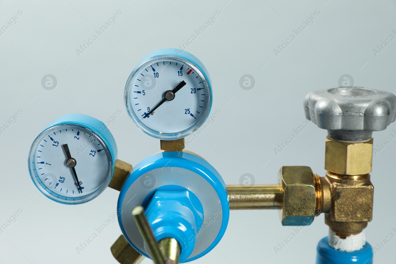 Photo of Pressure gauge of medical oxygen tank on light grey background, closeup