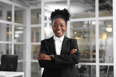 Photo of Happy woman with crossed arms in office. Lawyer, businesswoman, accountant or manager