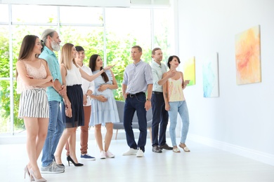 Photo of Group of people with guide at exhibition in art gallery