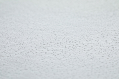 Water drops on light background, closeup view