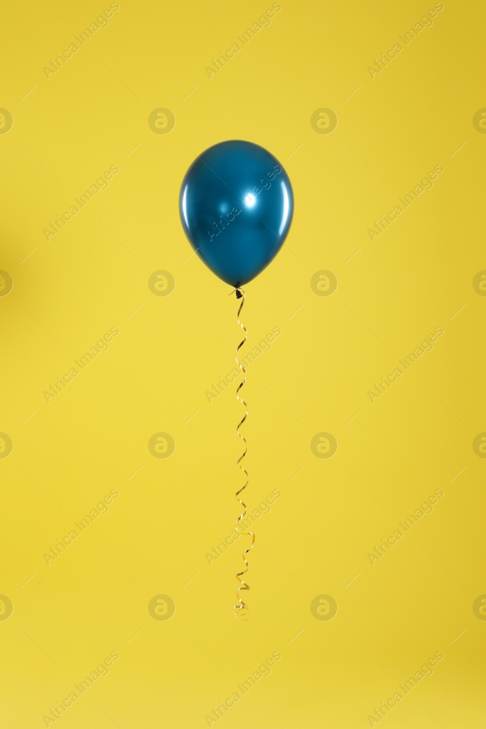 Photo of Bright balloon on color background. Celebration time