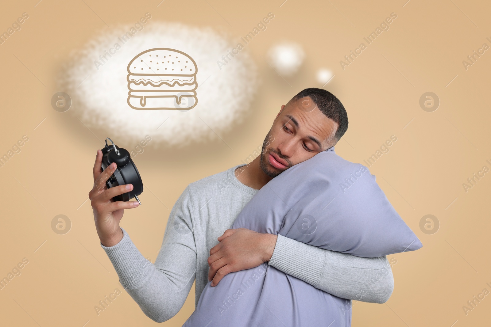 Image of Insomnia. Man with pillow looking at alarm clock on beige background. He can`t fall asleep because of hunger. Thought cloud with illustration of burger