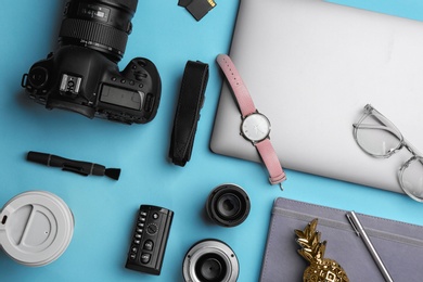 Flat lay composition with photographer's equipment and accessories on color background