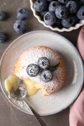 Tasty vanilla fondant with white chocolate and blueberries on grey table, flat lay
