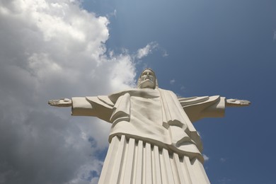 Photo of Truskavets, Ukraine - July 22, 2023: Beautiful statue of Christ the Redeemer against cloudy blue sky, low angle view