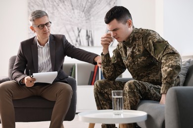 Professional psychotherapist working with military man in office
