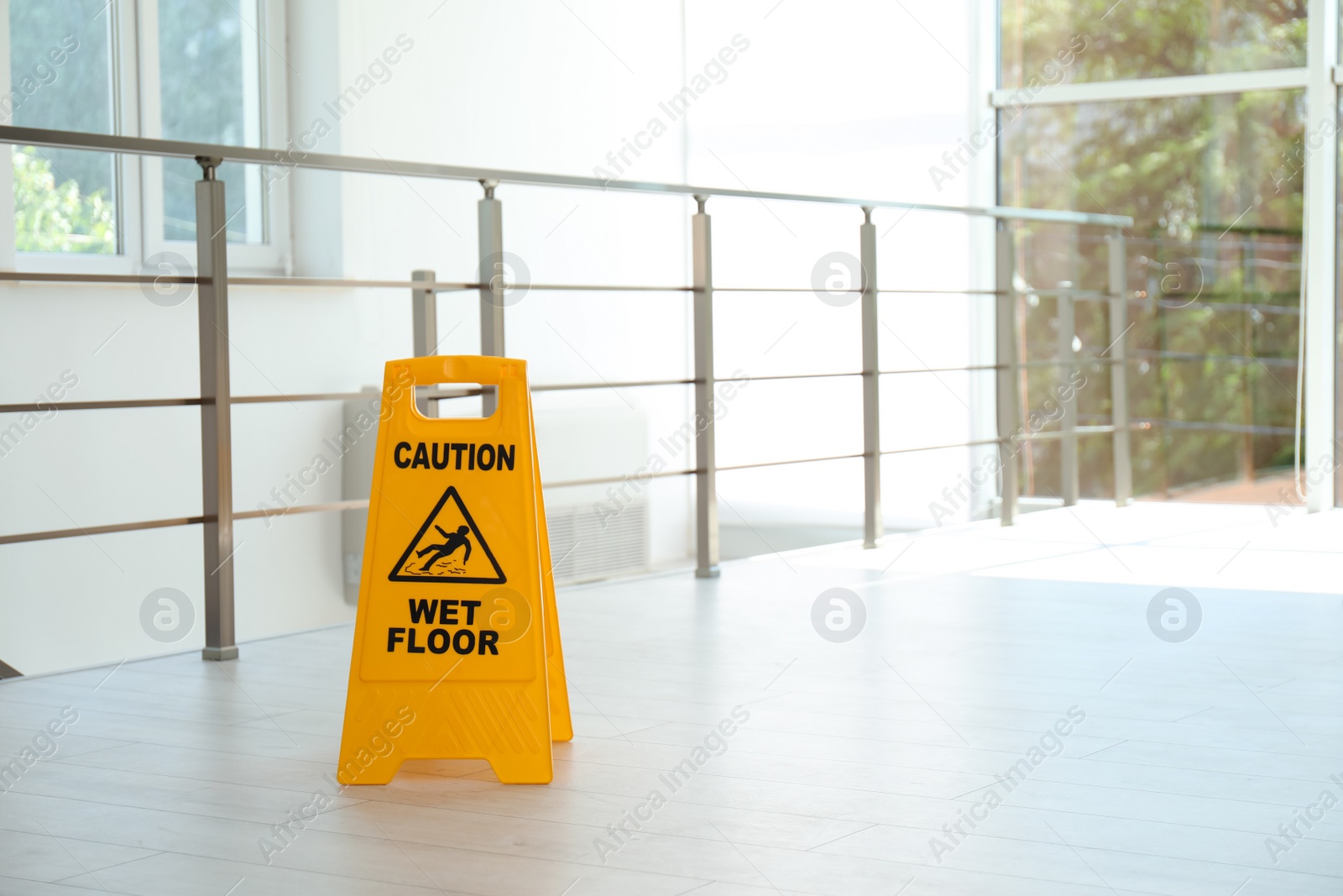 Photo of Safety sign with phrase Caution wet floor, indoors. Cleaning service