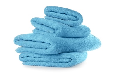 Photo of Stacked clean turquoise towels on white background